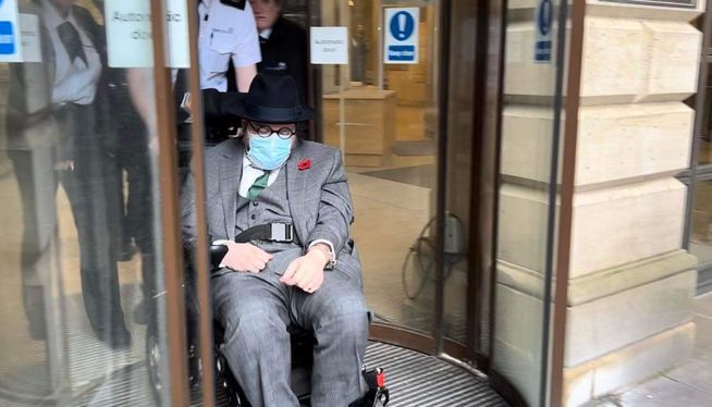 Nicholas Alahverdian, also known as Nicholas Rossi or Arthur Knight wheeled out of a court in Scotland as he unsuccessfully fought extradition to the United States in a series of hearings in 2023. Photo by Jane MacSorley of the "I Am Not Nicholas" podcast on Audible